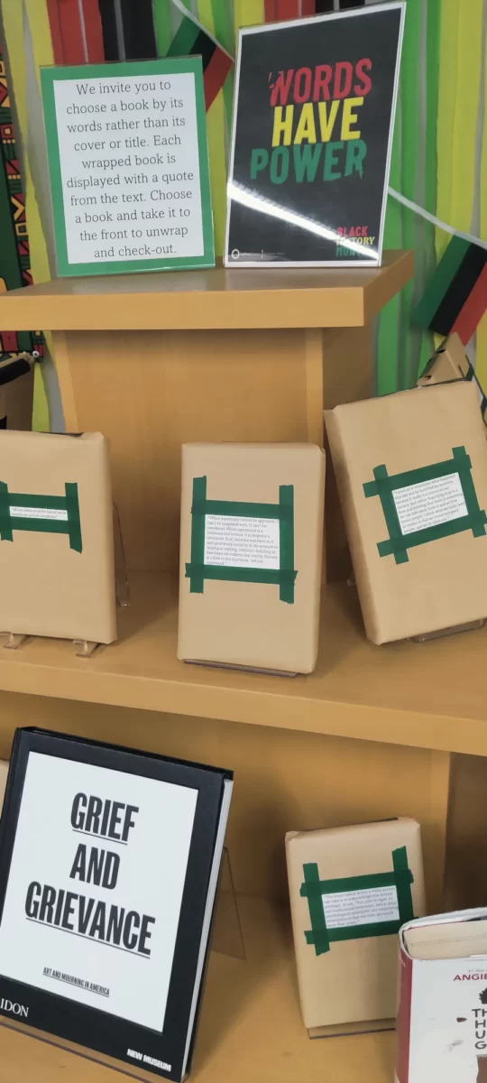 A book display with wrapped books featuring a passage from within the book.