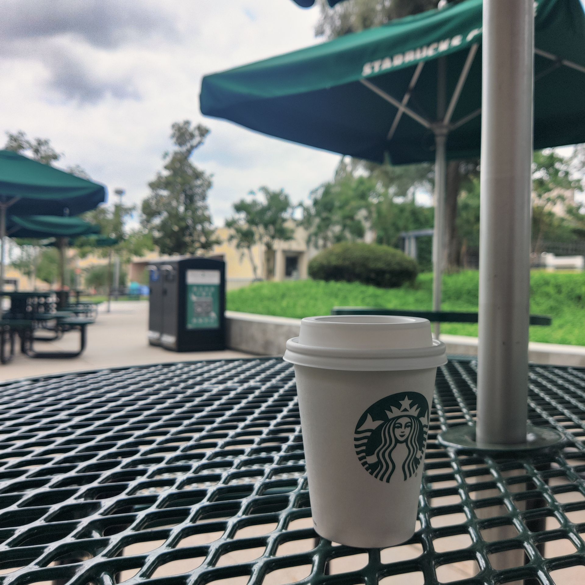 Starbucks paper cup on an outdoor table